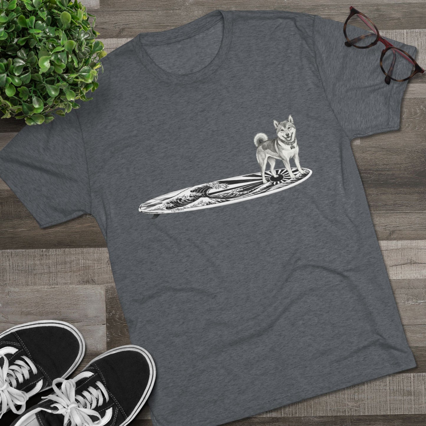 Gray t-shirt with a Shiba Inu dog on a surfboard with a Japanese wave art and flag graphic on it.