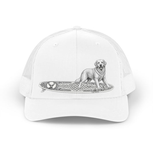White trucker hat with a Golden Retriever riding a long surfboard with keltic knots and embellishments.