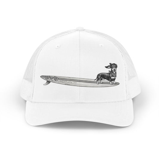 White trucker hat with Dachshund in checkered racing flag bandana on a wood grain racing flag surfboard illustration — The Swell Dogs