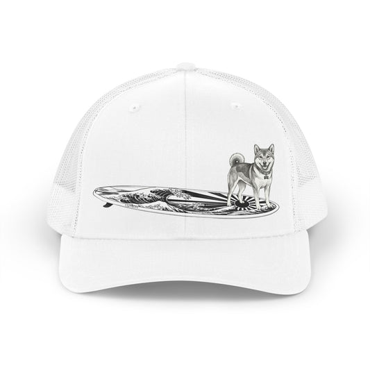 Shiba Inu surf trucker hat in white with black line drawing of Shiba Inu on a surfboard with rising wave and Japanese sun flag graphic — The Swell Dogs