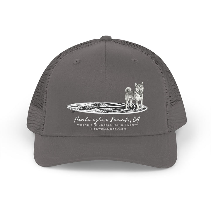 Grey trucker hat featuring a Shiba Inu dog standing on a Japanese surfboard with "Huntington Beach, CA" text