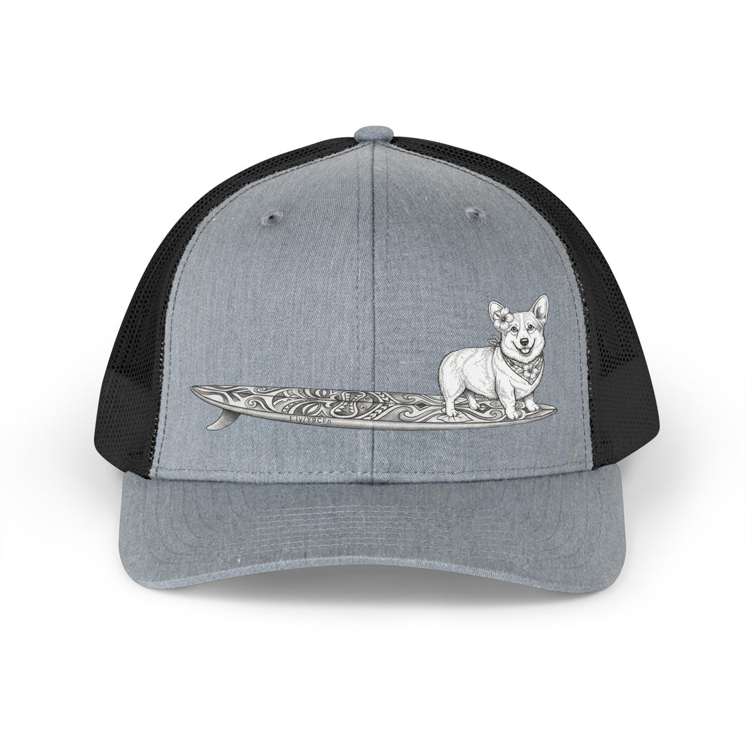 Gray and black trucker hat with vintage Corgi wearing hibiscus bandana and hibiscus in her ear on a tiki surfboard — The Swell Dogs