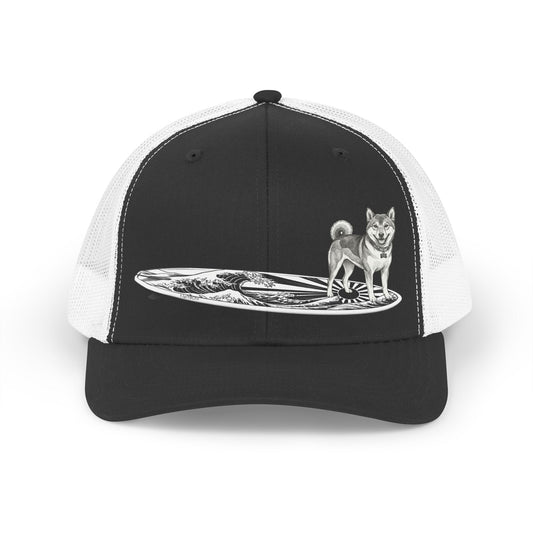 Shiba Inu surf trucker hat in black and white featuring a vintage line drawing of a Shiba Inu on a surfboard with rising wave and Japanese sun flag design — The Swell Dogs