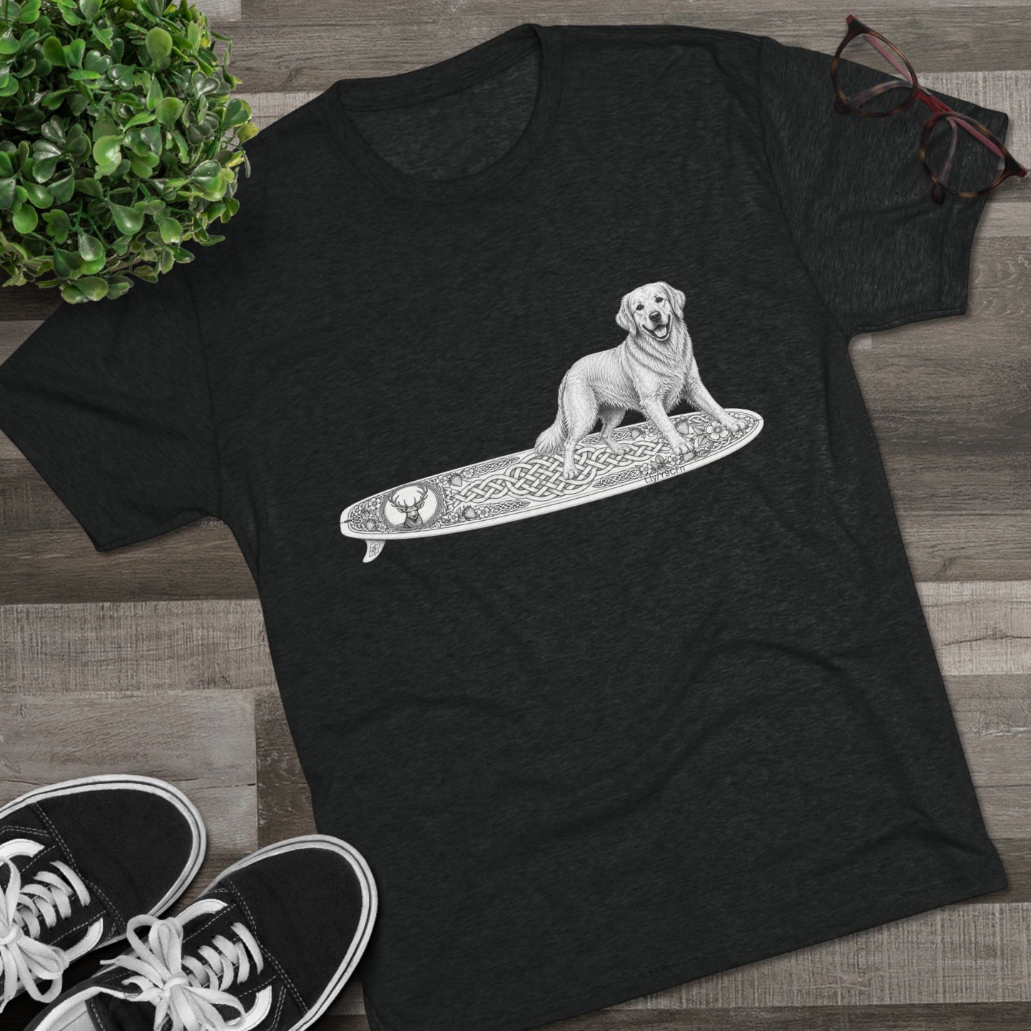 Black t-shirt with a Golden Retriever riding a long surfboard with keltic knots and embellishments.
