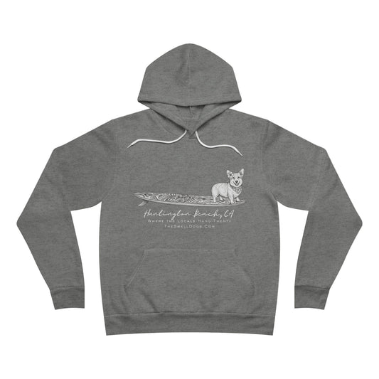 Grey pullover hoodie featuring a Corgi dog standing on a tiki surfboard with "Huntington Beach, CA" text