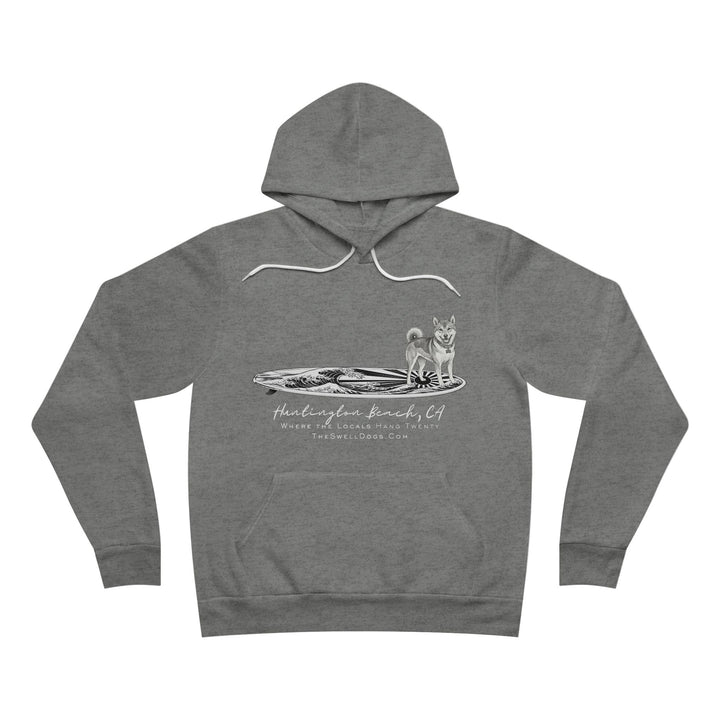 Gray pullover hoodie featuring a Shiba Inu dog standing on a surfboard with "Huntington Beach, CA" text