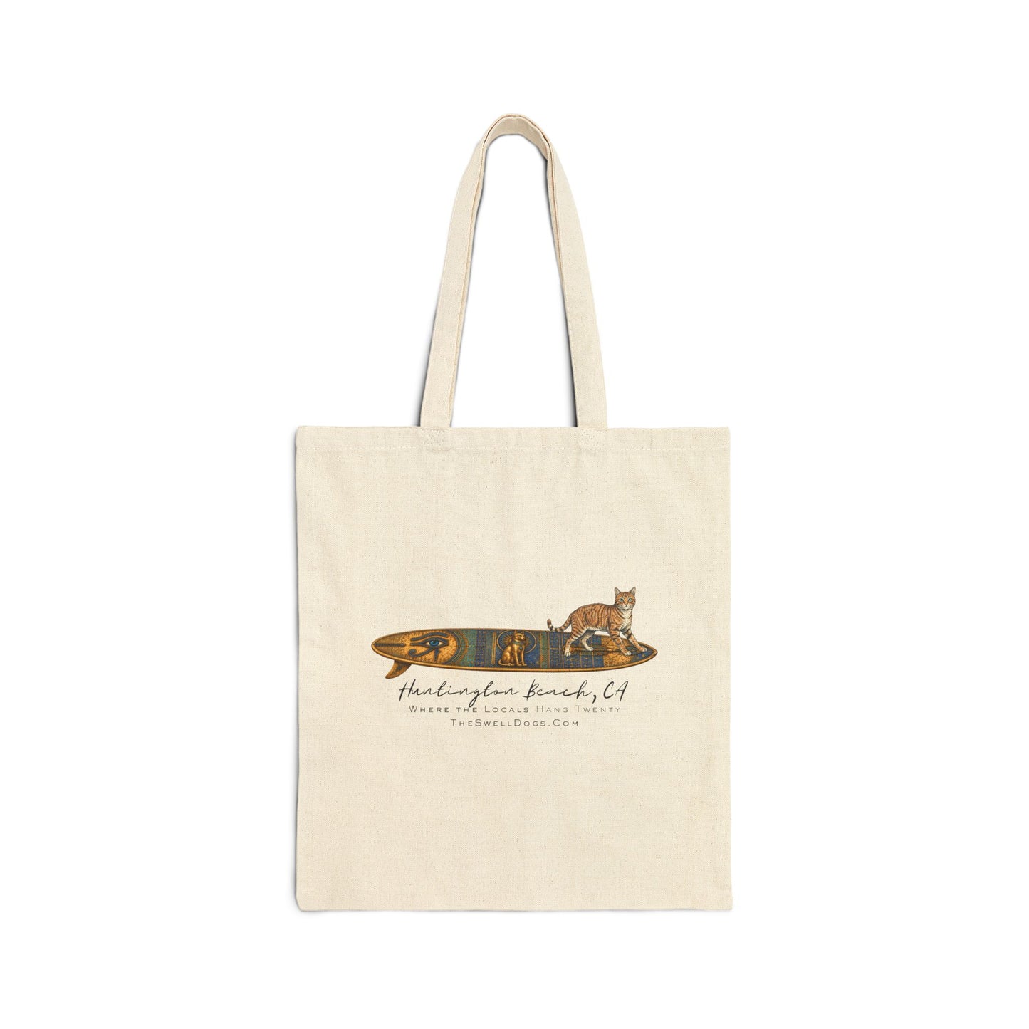 Beige tote bag featuring a tabby cat standing on an Egyptian surfboard with "Huntington Beach, CA" text