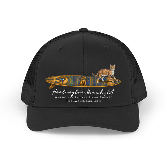 Adjustable black trucker hat featuring a tabby cat standing on an Egyptian surfboard with "Huntington Beach, CA" text