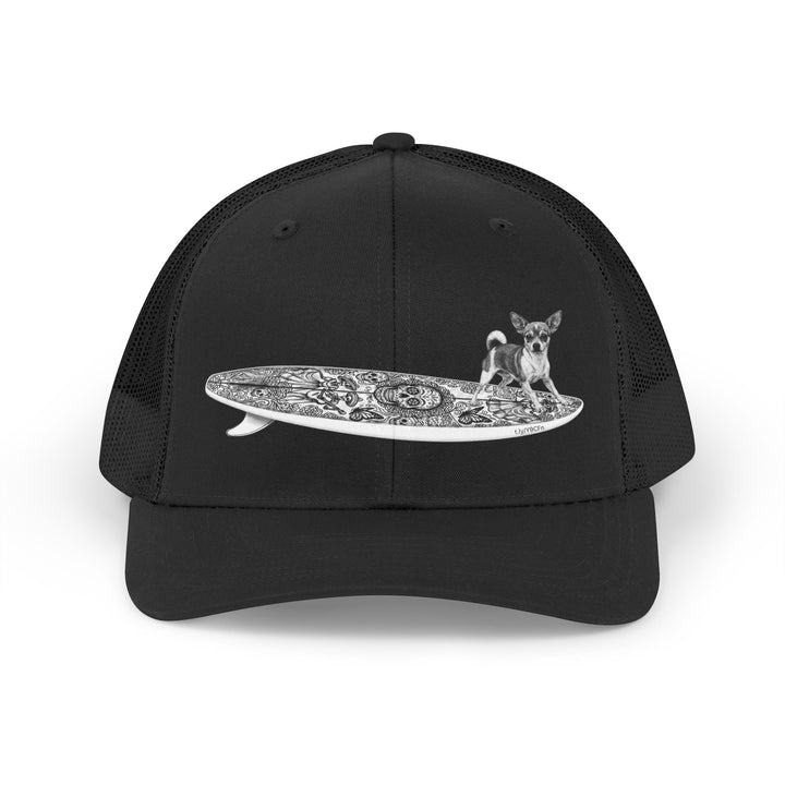 Black trucker hat with a Chihuahua surfing on a Day of the Dead surfboard. 