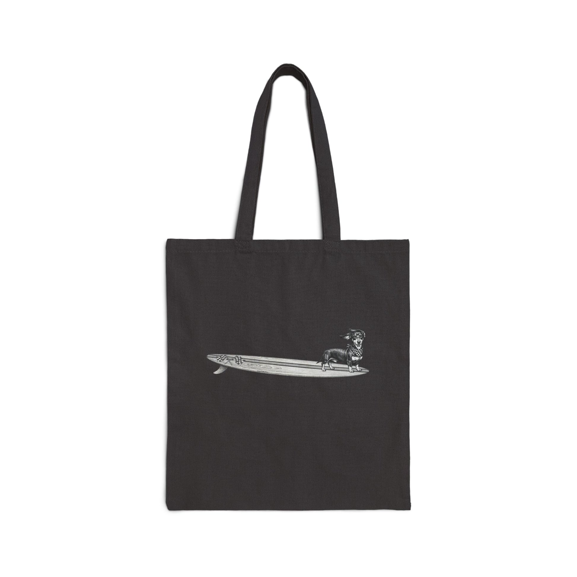 Black canvas tote bag with vintage Dachshund wearing a checkered racing flag bandana on a wood grain racing flag surfboard line drawing — The Swell Dogs