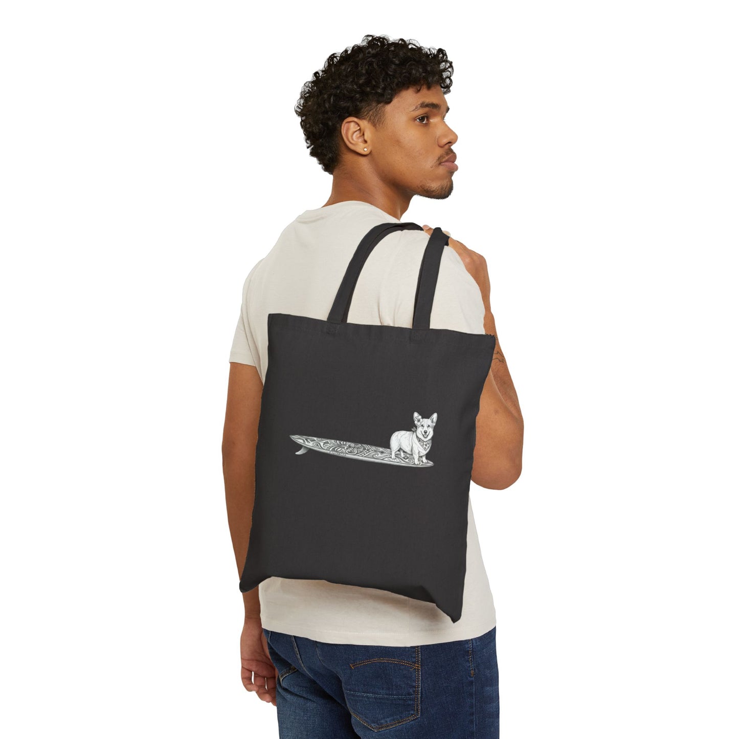 Man carrying black Corgi surf tote bag with hibiscus bandana tiki surfboard design over shoulder — The Swell Dogs