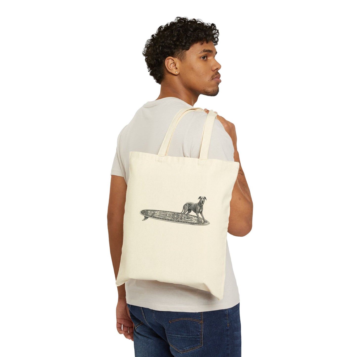 Man carrying a beige  tote bag with a Great Dane on a longboard with wild boar crests and suns on it.