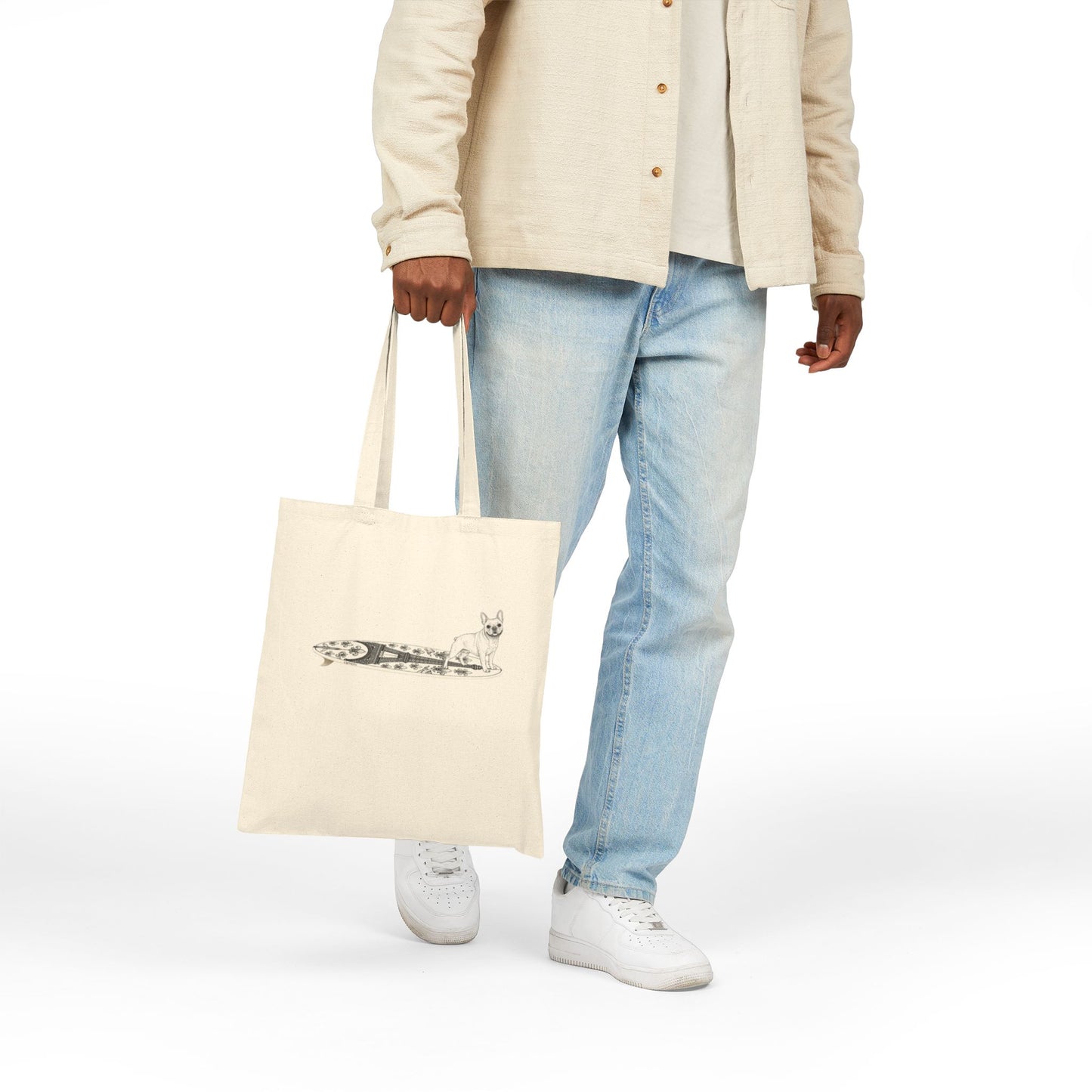 Person holding a Beige tote bag with a French Bulldog on an Eiffel Tower surfboard.