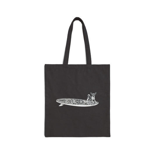 Black tote bag with a Chihuahua surfing on a Day of the Dead surfboard.