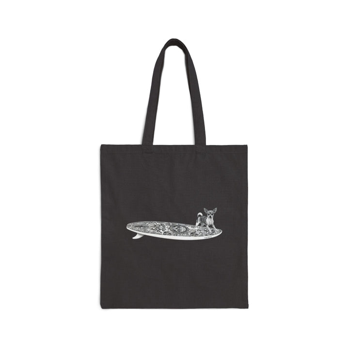 Black tote bag with a Chihuahua surfing on a Day of the Dead surfboard.