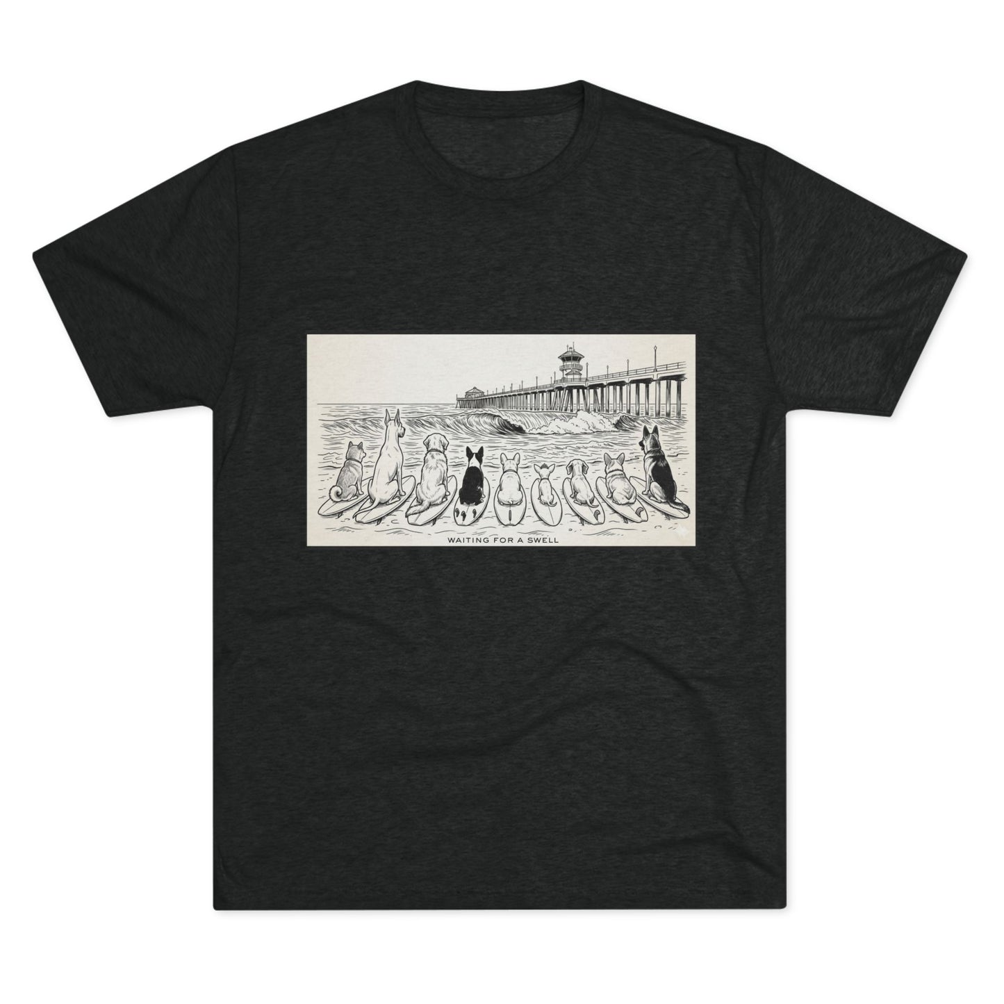 Black t-shirt with a pack of dogs on surfboards staring out to sea, with the words Waiting for a Swell' underneaath the dogs and the Huntington Beach pier in the background.