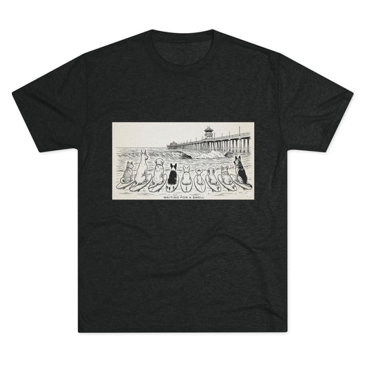 Black t-shirt with a pack of dogs on surfboards staring out to sea, with the words Waiting for a Swell' underneaath the dogs and the Huntington Beach pier in the background.