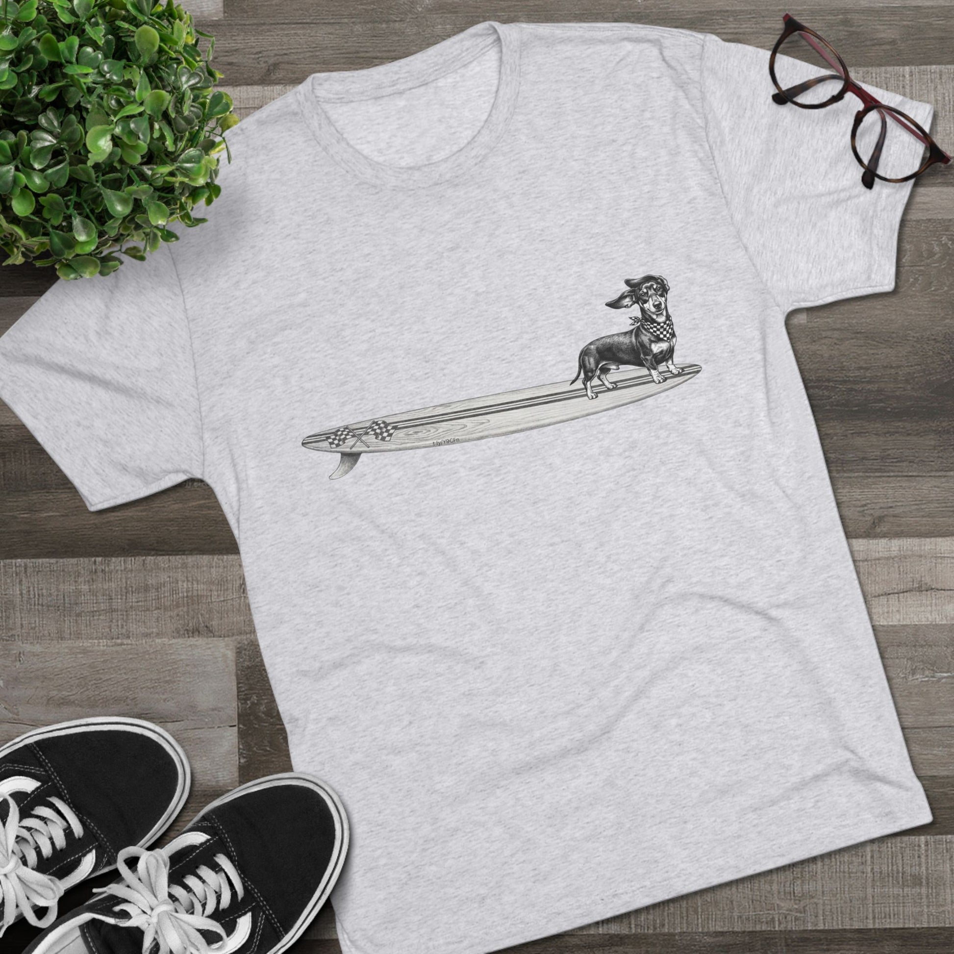 Light heather grey Dachshund surf t-shirt with checkered racing flag bandana and wood grain surfboard illustration styled with Vans and sunglasses — The Swell Dogs