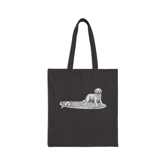 Black tote bag with a white Golden Retriever dog on a surfboard with a irish knot graphic on it.