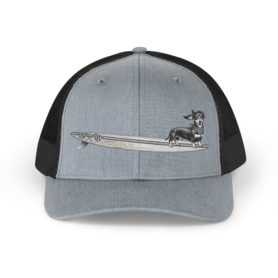Gray and black trucker hat with vintage Dachshund wearing checkered racing flag bandana on a wood grain racing flag surfboard — The Swell Dogs