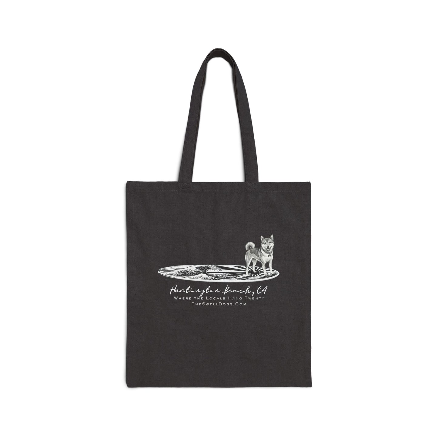 Black tote bag featuring a Shiba Inu dog standing on a Japanese surfboard with "Huntington Beach, CA" text