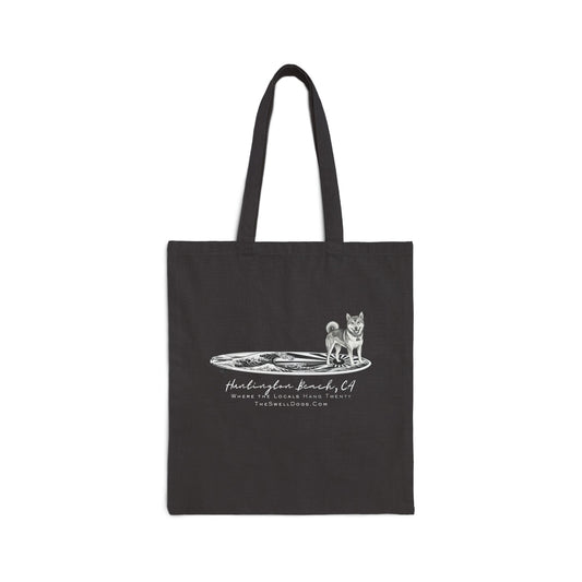 Black tote bag featuring a Shiba Inu dog standing on a Japanese surfboard with "Huntington Beach, CA" text