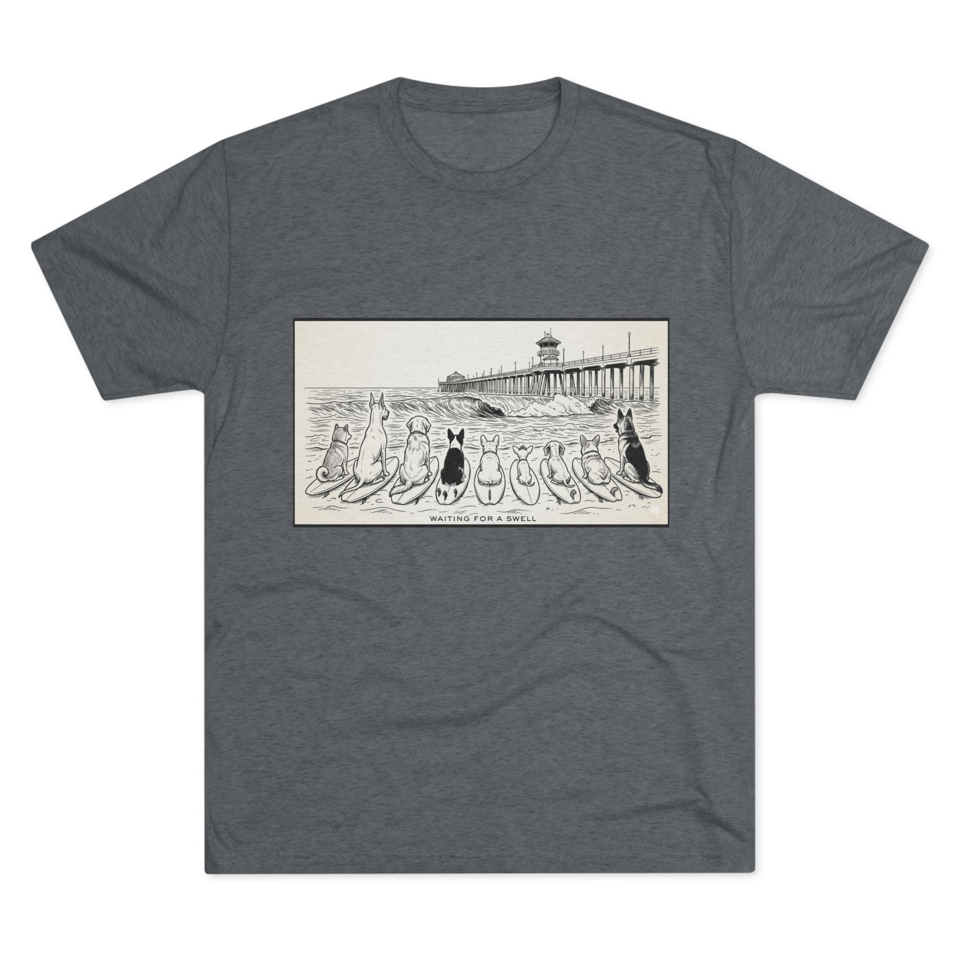 Gray tshirt with a pack of dogs on surfboards staring out to sea, with the words Waiting for a Swell' underneaath the dogs and the Huntington Beach pier in the background.