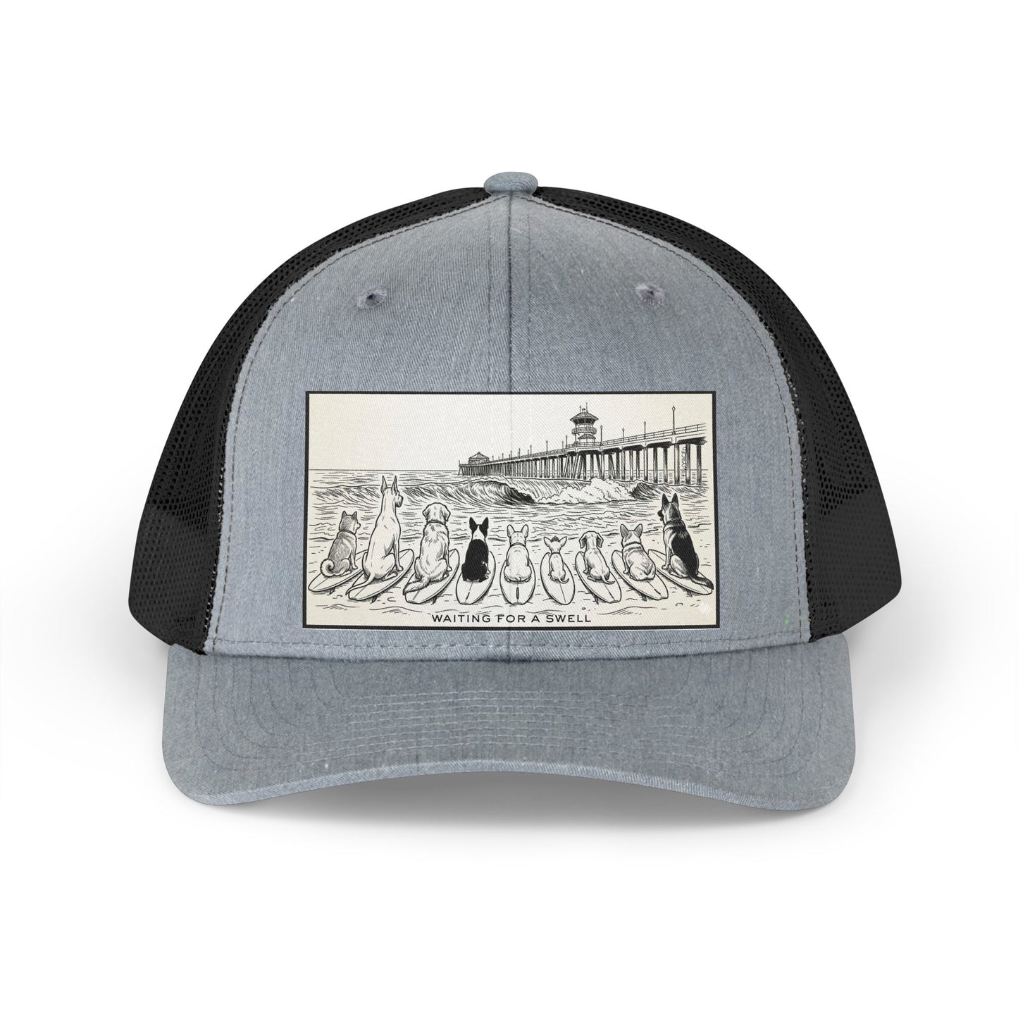 Gray and black trucker hat with a picture of a pack of nine dogs sitting on their surfboards, facing the ocean, with the Huntington Beach pier in the background. It says Waiting for a Swell at the bottom.