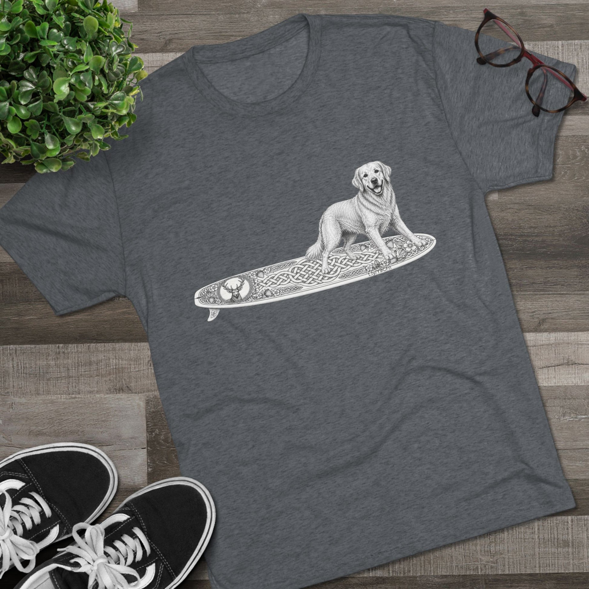Gray t-shirt with a Golden Retriever riding a long surfboard with keltic knots and embellishments.