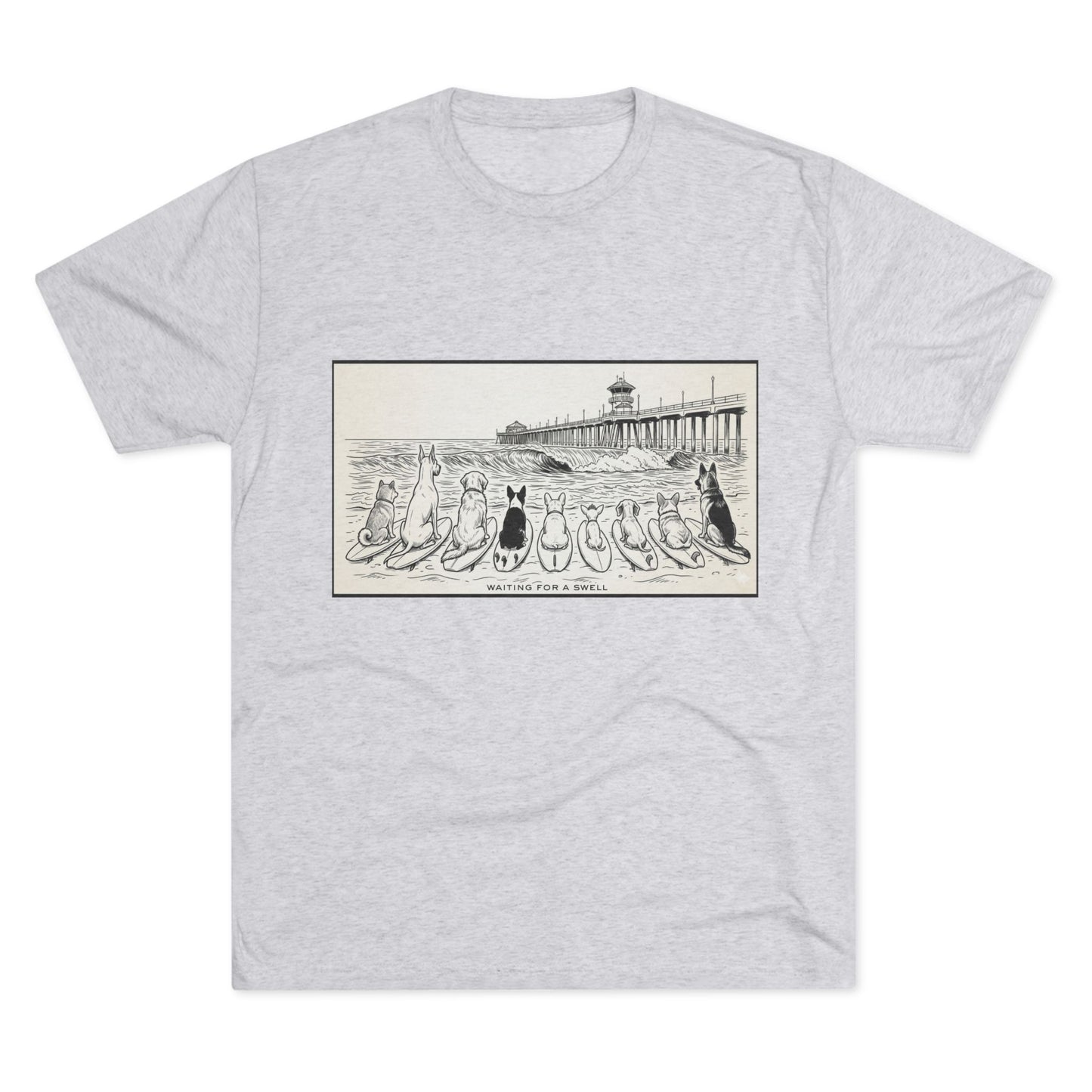 White t-shirt with a pack of dogs on surfboards staring out to sea, with the words Waiting for a Swell' underneaath the dogs and the Huntington Beach pier in the background.