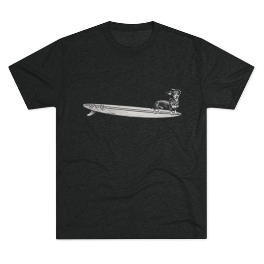 T-shirt with a graphic of a Dachshund dog on a racing flags surfboard with a racing checkered bandana on it's neck.