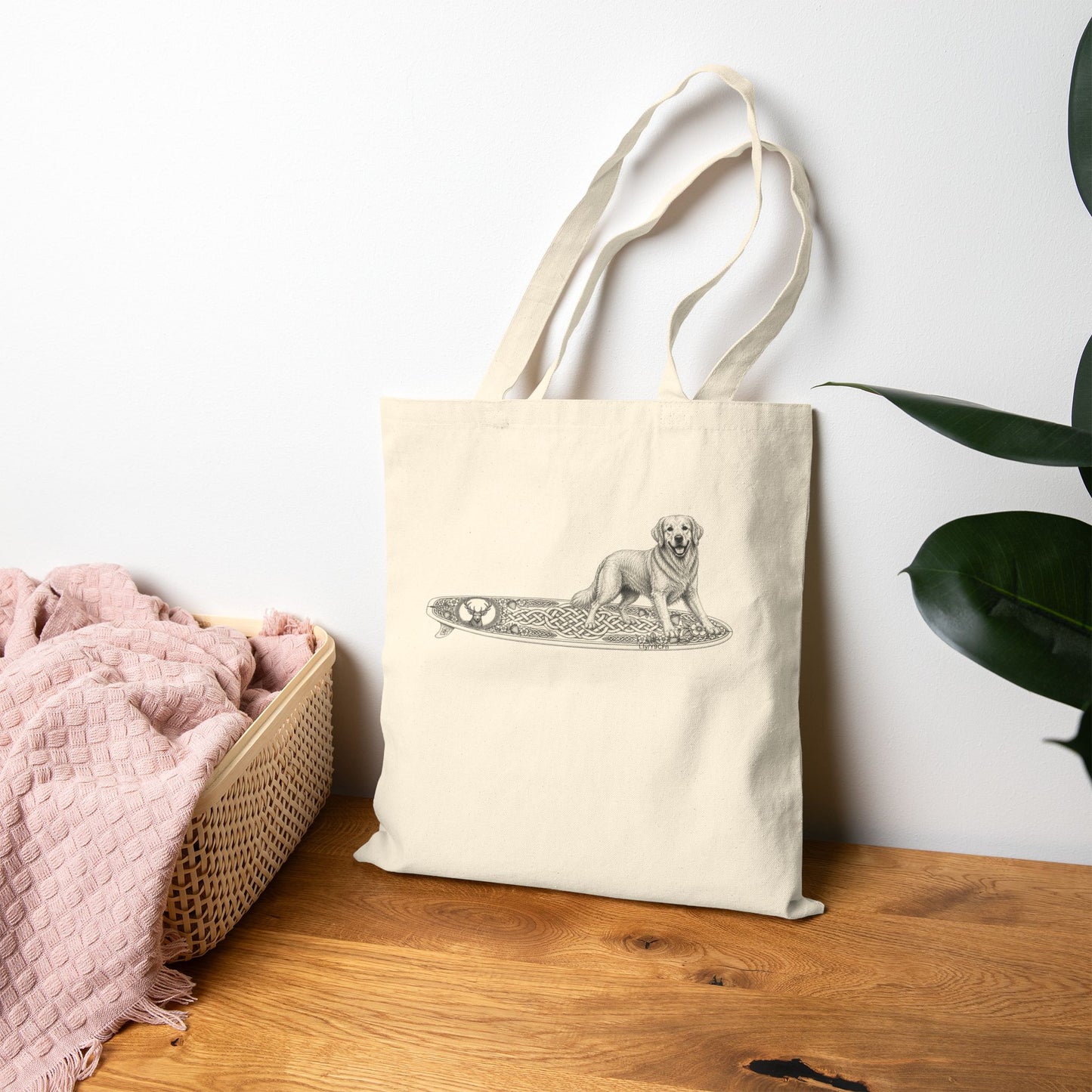 Beige tote bag with a Golden Retriever riding a long surfboard with keltic knots and embellishments.