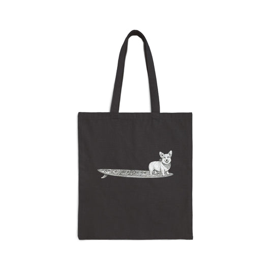Black canvas tote bag with vintage Corgi wearing hibiscus bandana and hibiscus in her ear on a tiki surfboard line drawing — The Swell Dogs
